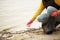 Hand of volunteer lift off litter beach. Spring cleaning in coastline, outdoor trash and rubbish