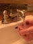 Hand washing under warm running tap water