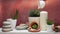 Hand watering succulent plant on white shelf with cactus and room decorations against old brick color wall