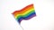 Hand waving gay or lgbt pride rainbow colored flag
