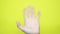 Hand waving, saying goodbye gesture isolated yellow background