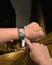 Hand wearing ultra-thin curved-screen smart watch with apps