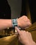 Hand wearing wrist watch with GPS