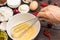 Hand whisk eggs in bowl with whisk. Flour, milk, berries Ingredients for cooking breakfast
