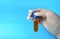 Hand with white glove with a laboratory sample on blue background. medical concept