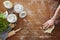 Hand wiping flour on wooden workspace atmospheric kitchen scene