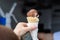 Hand of a woman buying an ice cream with two scoops of vanilla and chocolate flavours, at a street food market