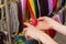 Hand of woman with colorful necklace on stall at the bazaar