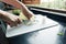 Hand of woman is cutting Nappa cabbage on a cutting board With knife in the kitchen