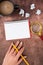 Hand Of Woman Having Spiral Notebook With Copy Space, Pencil, Magnifying Glass, Coffee Cup And Crumpled Papers