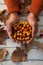 Hand of woman holding bowl of autumn berries