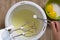 Hand of woman holding measure spoon with cream tartar to put it into egg whites before beating