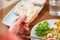 Hand of woman holding piece of bread