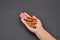 Hand of a woman holding a pile of cinnamon pods isolated on black background. Spice. Taste. Cooking. Food and beverage flavoring