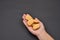 Hand of a woman holding a pile of crackers isolated on black background. Spice. Taste. Cooking. Food and beverage flavoring