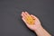 Hand of a woman holding a pile of fresh fusilli on blac