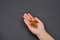 Hand of a woman holding a pile of peeled walnuts isolated on black background. Spice. Taste. Cooking. Food and beverage flavoring