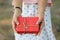 hand of a woman holding a red gift box in concept of a special d