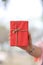 hand of a woman holding a red gift box in concept of a special d