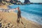 Hand of woman holding seaweed on the beach