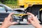 Hand of woman holding smartphone and take photo of car accident