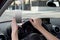Hand of woman holding steering wheel and mobile phone driving car while texting distracted in risk