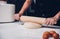 Hand of woman making dough with rolling wooden