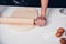 Hand of woman making dough with rolling wooden