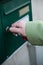 Hand of woman open mailbox with keys