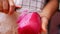 Hand of woman peeling the red radish to prepare delicious food in kitchen at home. Cooking concept.