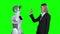 Hand of a woman and a robot hand give five. Green screen