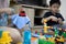 Hand of woman is spraying alcohol antiseptic,disinfecting spray,cleaning her son`s toys at home,prevent infection of Covid-19,