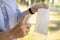 Hand of woman is spraying alcohol on medical mask,clean washing for reuse,disinfecting mask using spray alcohol cleaning after