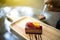 The hand of a woman using a spoon to scoop fruit cakes. Close up shot