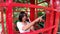 Hand women  holding telephone and dial numbers on a telephone box