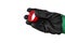 A hand in a working rubberized glove holds a red cap. Isolate on a white background.