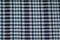 Hand woven traditional cotton fabric in shades of dyed blue and white plaid pattern background