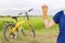 Hand with a wrist brace, orthopedic equipment with yellow bicycle in green filed.