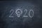 Hand write 2020 with light idea on blackboard