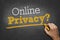 Hand writes chalk text on blackboard - online privacy