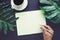 Hand Writing on blank notepaper with tropical leaves