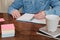 Hand writing on a copy book on wooden desk