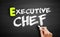 Hand writing executive chef on blackboard, concept background