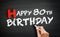 Hand writing Happy 80th birthday on blackboard, holiday concept background