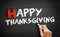 Hand writing Happy Thanksgiving on blackboard, concept