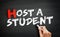 Hand writing Host a Student on blackboard, concept background