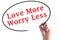 Hand writing Love More Worry Less on transparent board