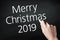 Hand writing merry christmas 2019