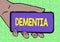 Hand writing sign Dementia. Word Written on the general word for diseases and disorders with a loss in memory Adult Hand