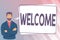Hand writing sign Welcome. Business overview instance or manner of greeting someone in polite or friendly way Man